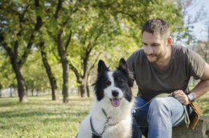 Man with his dog playing in the park